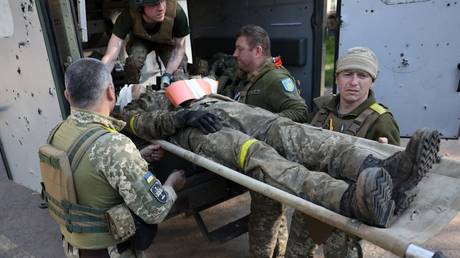 Military medics evacuate a wounded Ukrainian serviceman near the front line in Donetsk Region, Russia, June 5, 2023