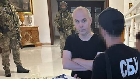 Ukrainian MP Nestor Shufrich talking to officers of Ukraine’s Security Service (SBU) at his home.