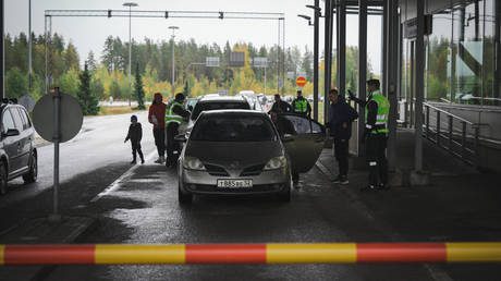 FILE PHOTO: Finnish border guard officers check cars approaching the Vaalimaa border crossing between Finland and the Russian Federation.