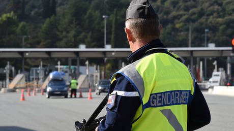 FILE PHOTO. A French police officer patrols at the French-Italian border in Menton.