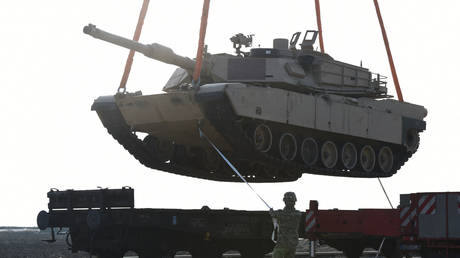 FILE PHOTO: A US soldier helps to manoever an Abrams tank from a railway car.